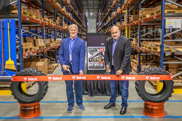 Mike Ballweber, Bobcat Company North America President(left), and Fabio Duque, APL Logistics Regional Vice President are cutting the ribbon in celebration of the opening of the Atlanta parts distribution center.