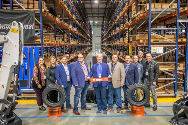 Mike Ballweber, Bobcat Company North America President(fifth from left), and employees are taking pictures to mark the opening of the Atlanta parts distribution center.