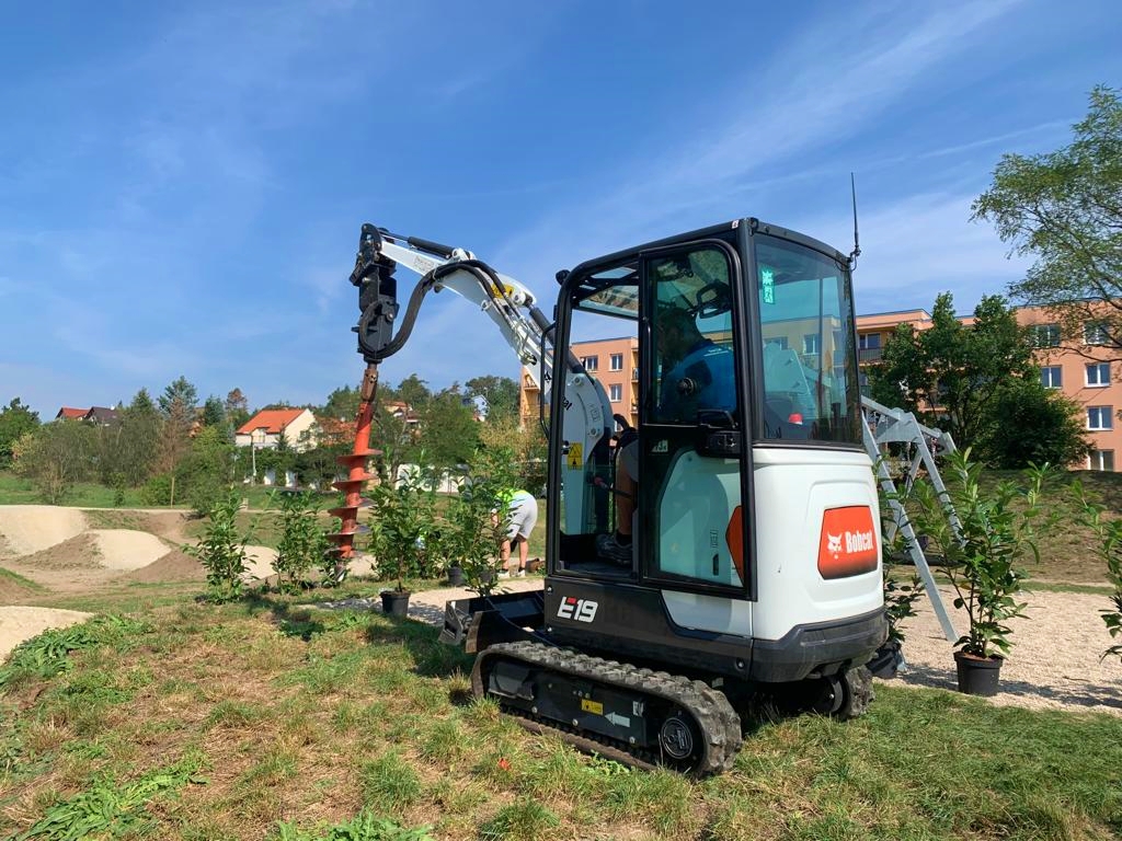 Trees and flowers are being planted with a Doosan Bobcat excavator in the Czech Republic.