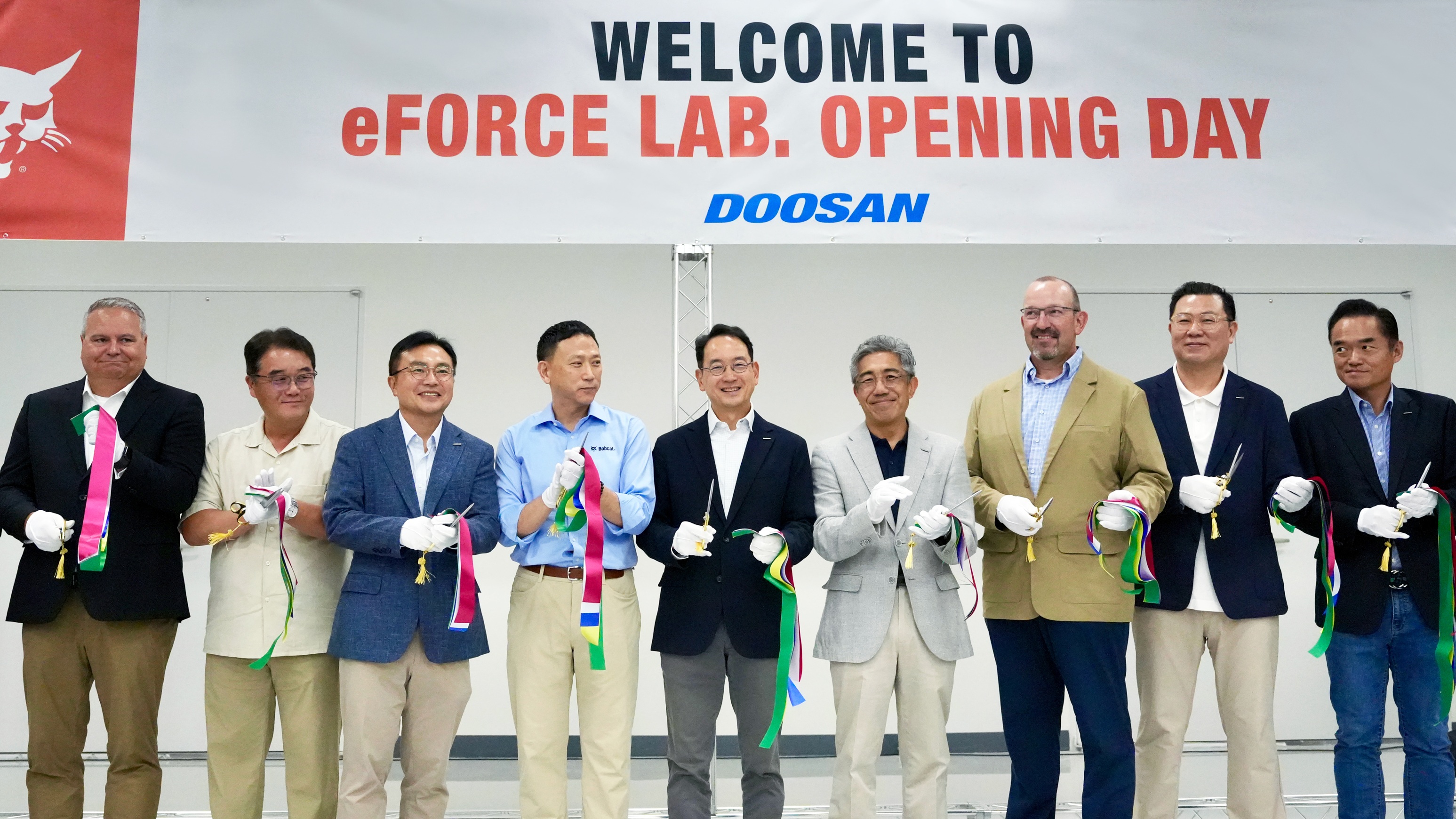 Key executives take part in the ribbon cutting ceremony to celebrate the opening of Doosan Bobcat’s 'eFORCE LAB.' battery pack research center. Pictured in the center: Scott Park, CEO and Vice Chairman of Doosan Bobcat; and fourth from the left: Hyungwon (HW) Park, President of Doosan Bobcat ALAO.